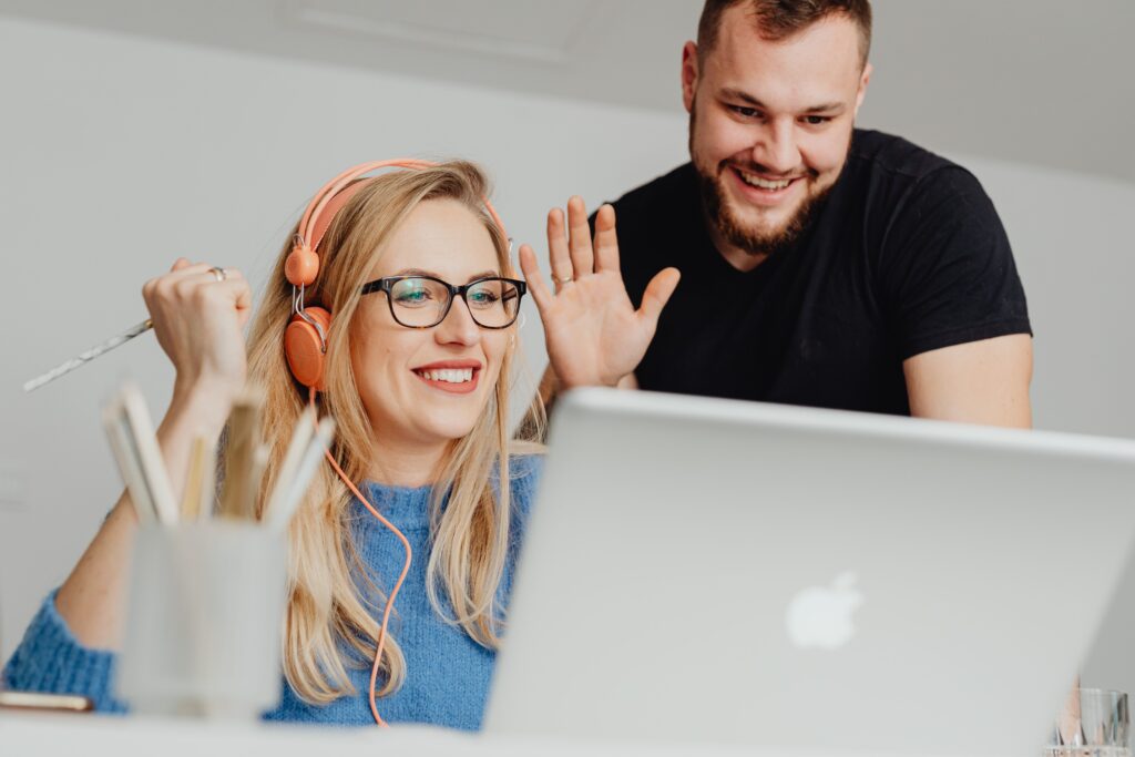 A man and woman engaged in an online video call, enjoying a moment together.